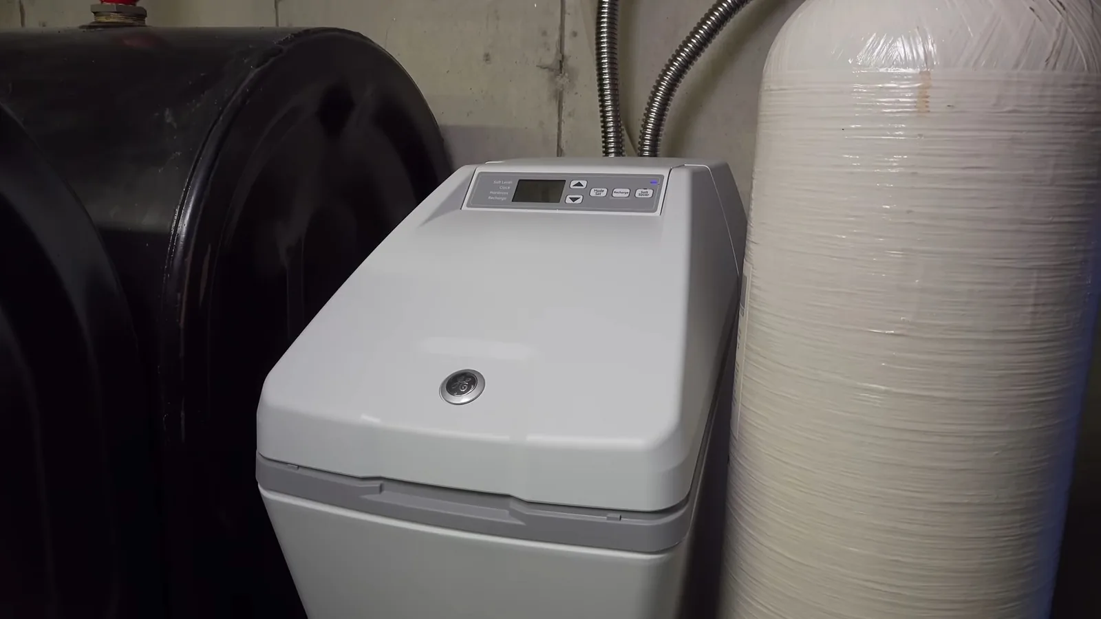 Gray water softener with a digital control panel standing beside a large white resin tank and a black tank
